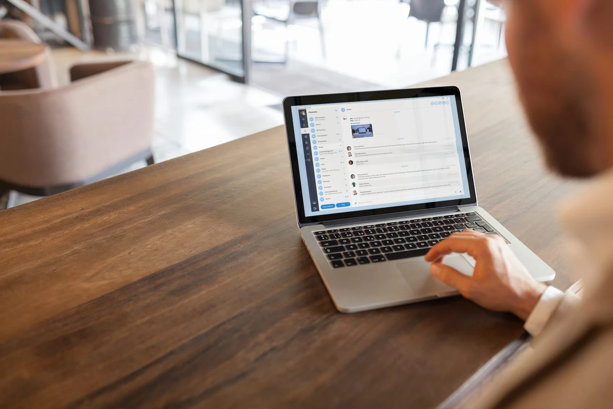 Businessman collaborating with his team on a laptop